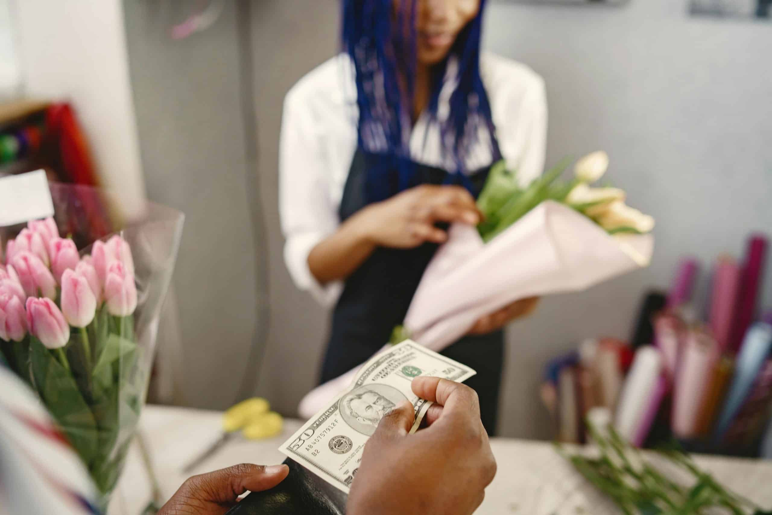 customer paying cash for flowers
